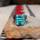 Turquoise inlay ring by Donald Douglas with Man in the Maze design.