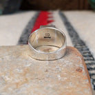 Turquoise inlay ring by Donald Douglas with Man in the Maze design.