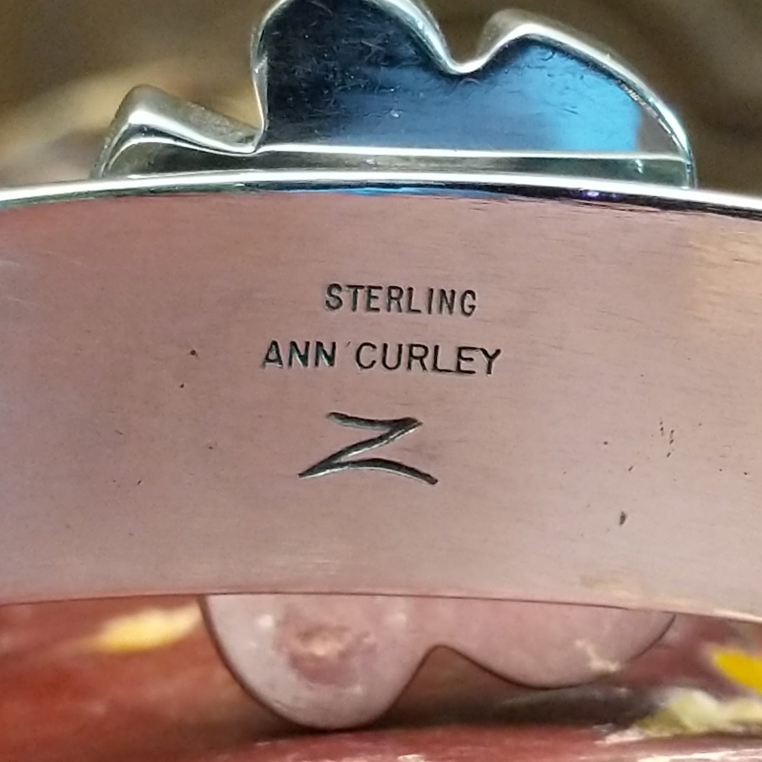 Close-up of the artisan's stamped signature.