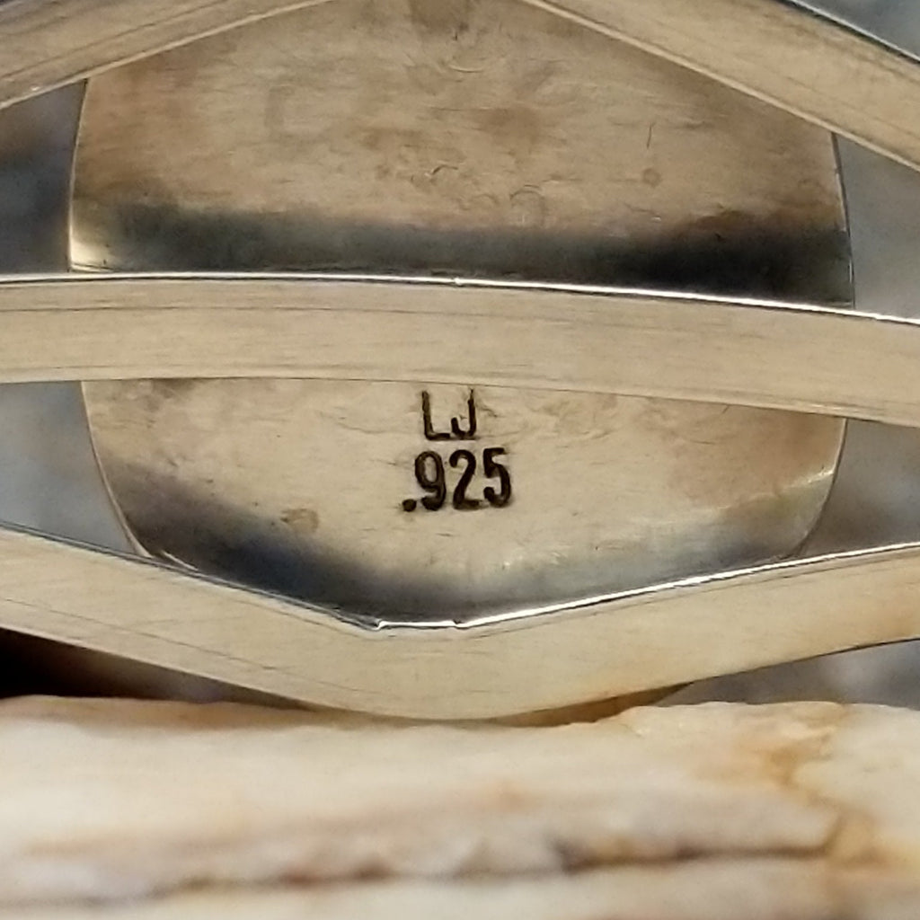 Close-up of the artisan's stamped initials.