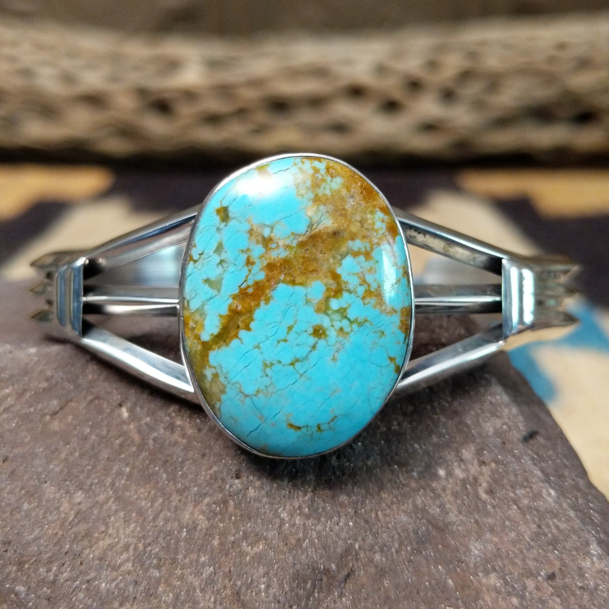 Turquoise Mountain turquoise cuff by Lucy Jake, featuring a blue turquoise stone with a natural brown matrix set in a handcrafted sterling silver cuff.