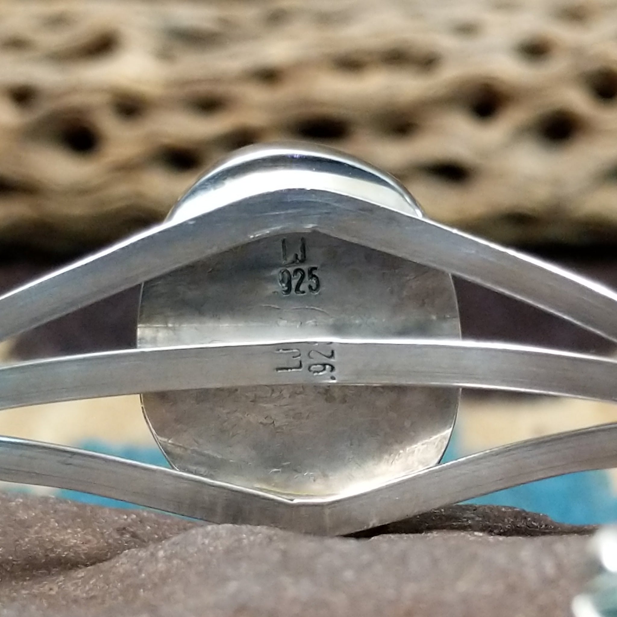 Turquoise Mountain turquoise cuff by Lucy Jake, featuring a blue turquoise stone with a natural brown matrix set in a handcrafted sterling silver cuff; artisan and Sterling Silver stamp.