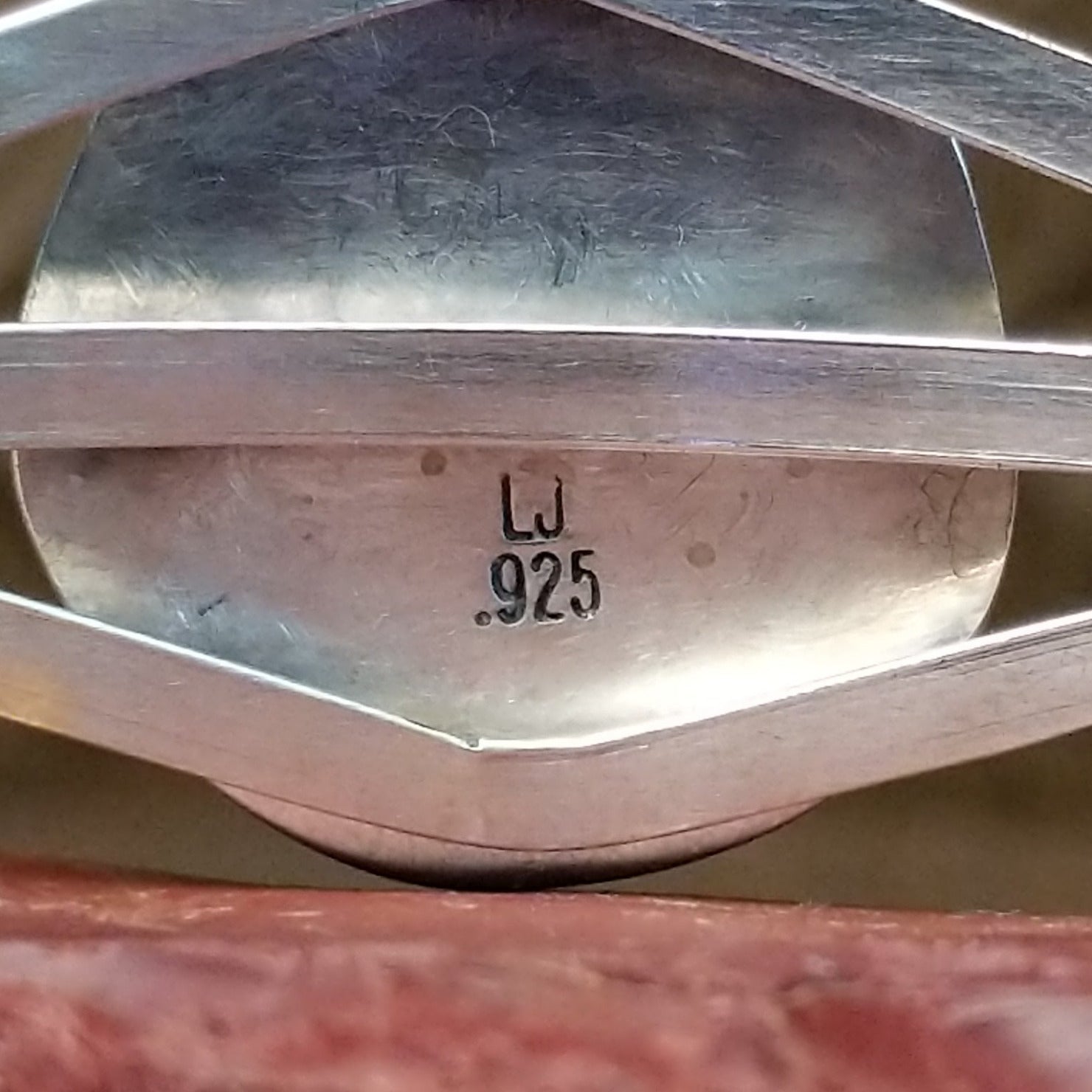 Close-up of the artist's stamped signature.