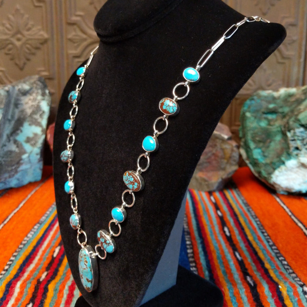 Turquoise set in oval bezels, linked together on a chain.