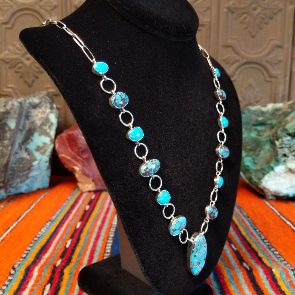 Turquoise set in oval bezels, linked together on a chain.