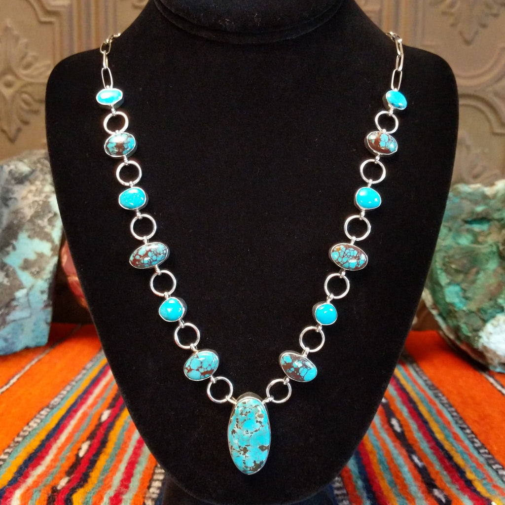 Turquoise set in oval bezels, linked together on a chain.