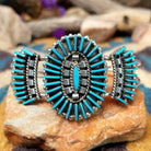 Handcrafted sterling silver cuff by Barton Cooeyate featuring a turquoise needlepoint concho centerpiece with matching side conchos, twisted rope detailing, silver bead accents, and a triple-shank cuff.