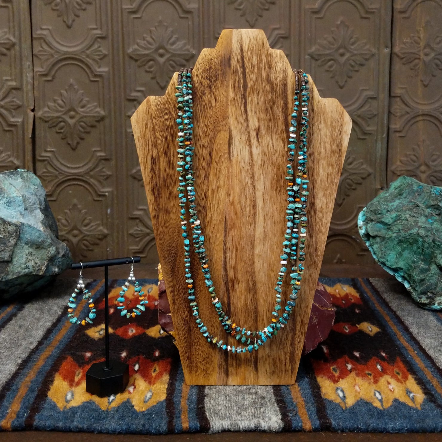 The multi-strand necklace with matching dangle earrings, both showcasing turquoise and orange spiny oyster shell heishi beads.