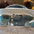 Close up of artist's stamped signature.