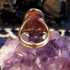 The thin band of the gold ring.