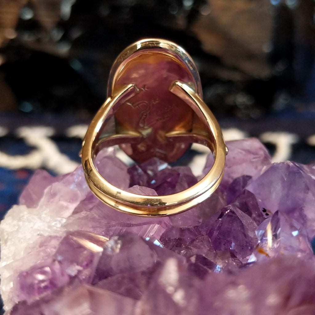 The thin band of the gold ring.