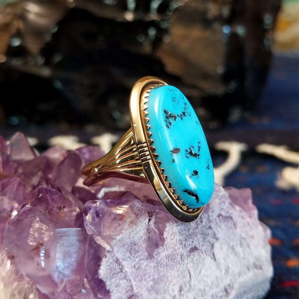 Side view showing the ring’s tapered gold band and elevated bezel.