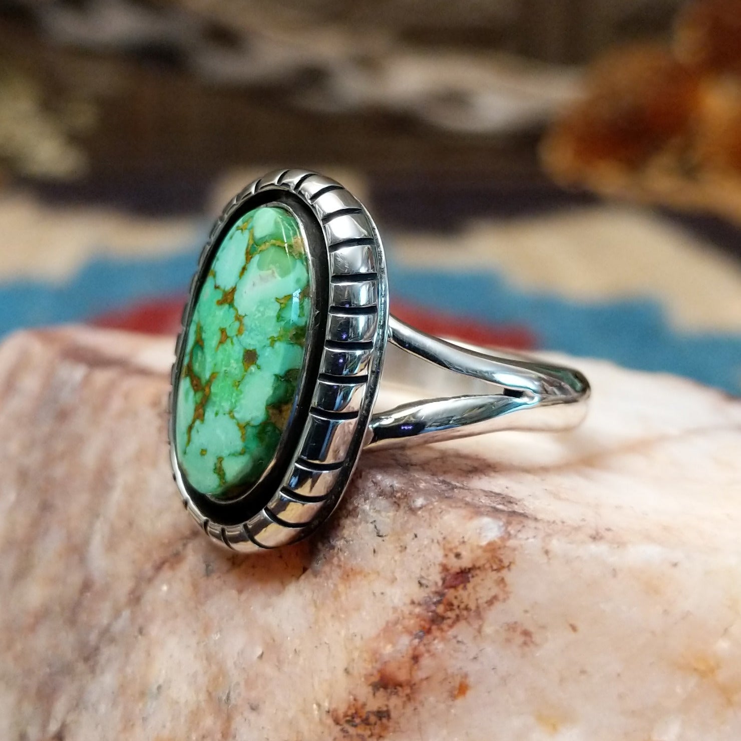 Sterling silver ring with turquoise set in the oval bezel that is framed by the shadowbox setting.