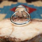 Sterling silver ring with turquoise set in the oval bezel that is framed by the shadowbox setting.