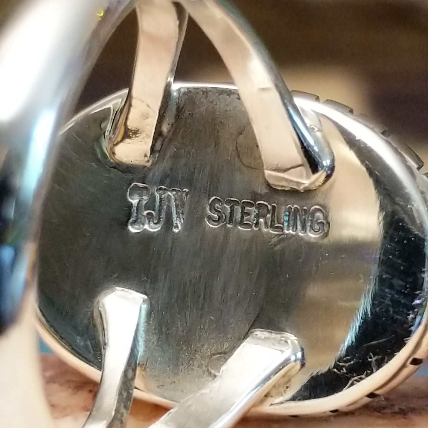 Close-up of the artisan's stamped signature.