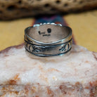 Turquoise round ring by Raymond Coriz, featuring a round turquoise stone set in a handcrafted sterling silver ring with an intricately detailed hand-stamped band.  Underside view.