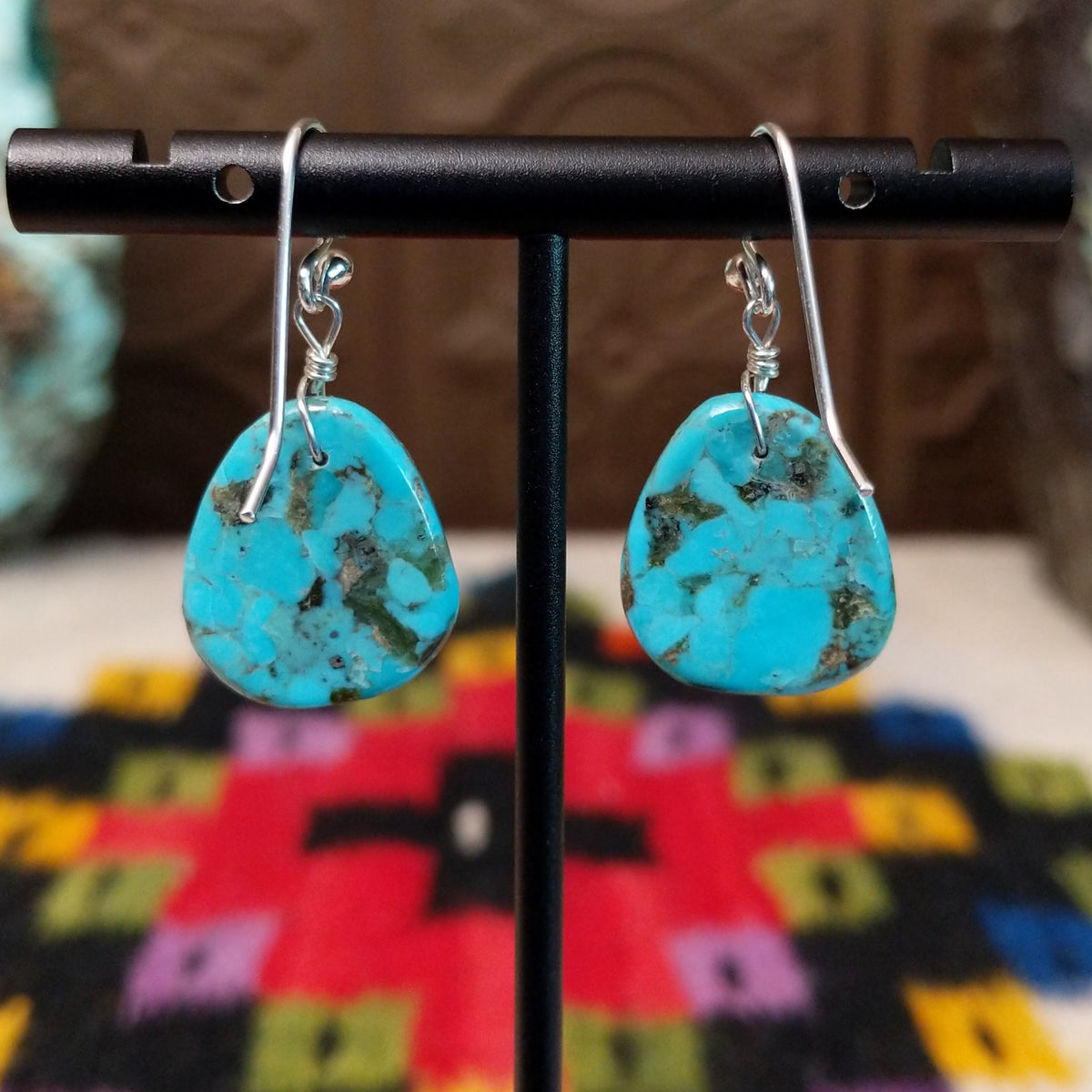Turquoise Slab Earrings by Ronald Chavez featuring polished freeform blue turquoise stones with natural brown, gray, and green matrix, suspended from simple silver-tone hooks; backside view.