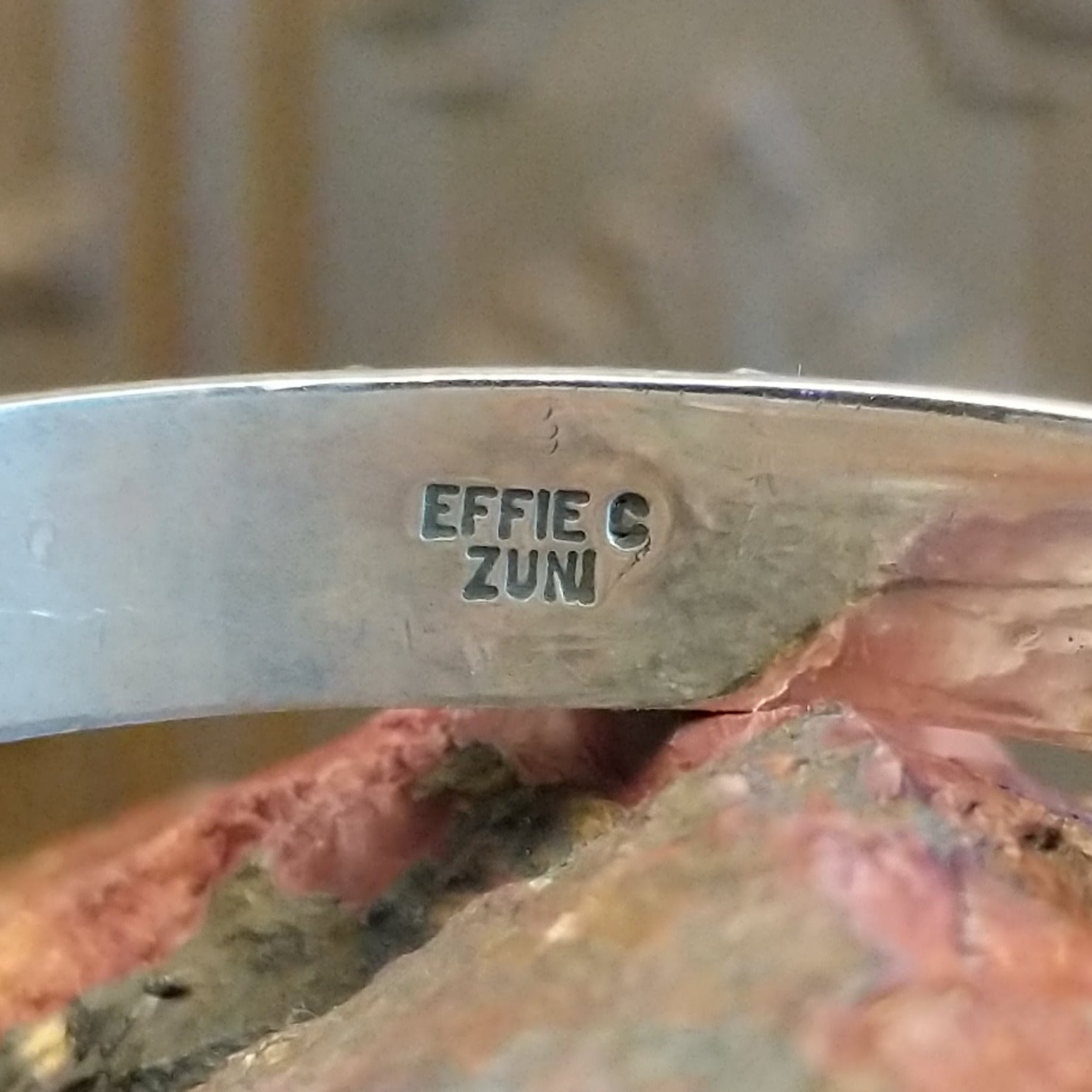 Close-up of the artisan's stamped signature.