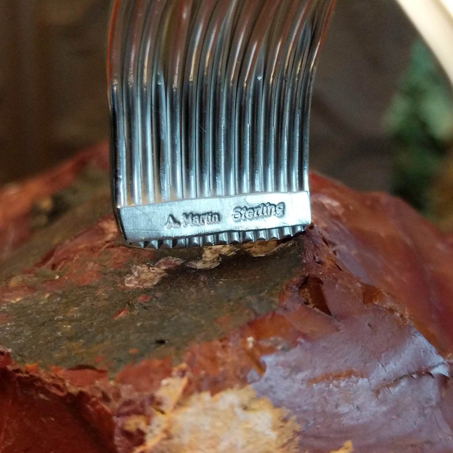 Close-up of the artisan's stamped signature.