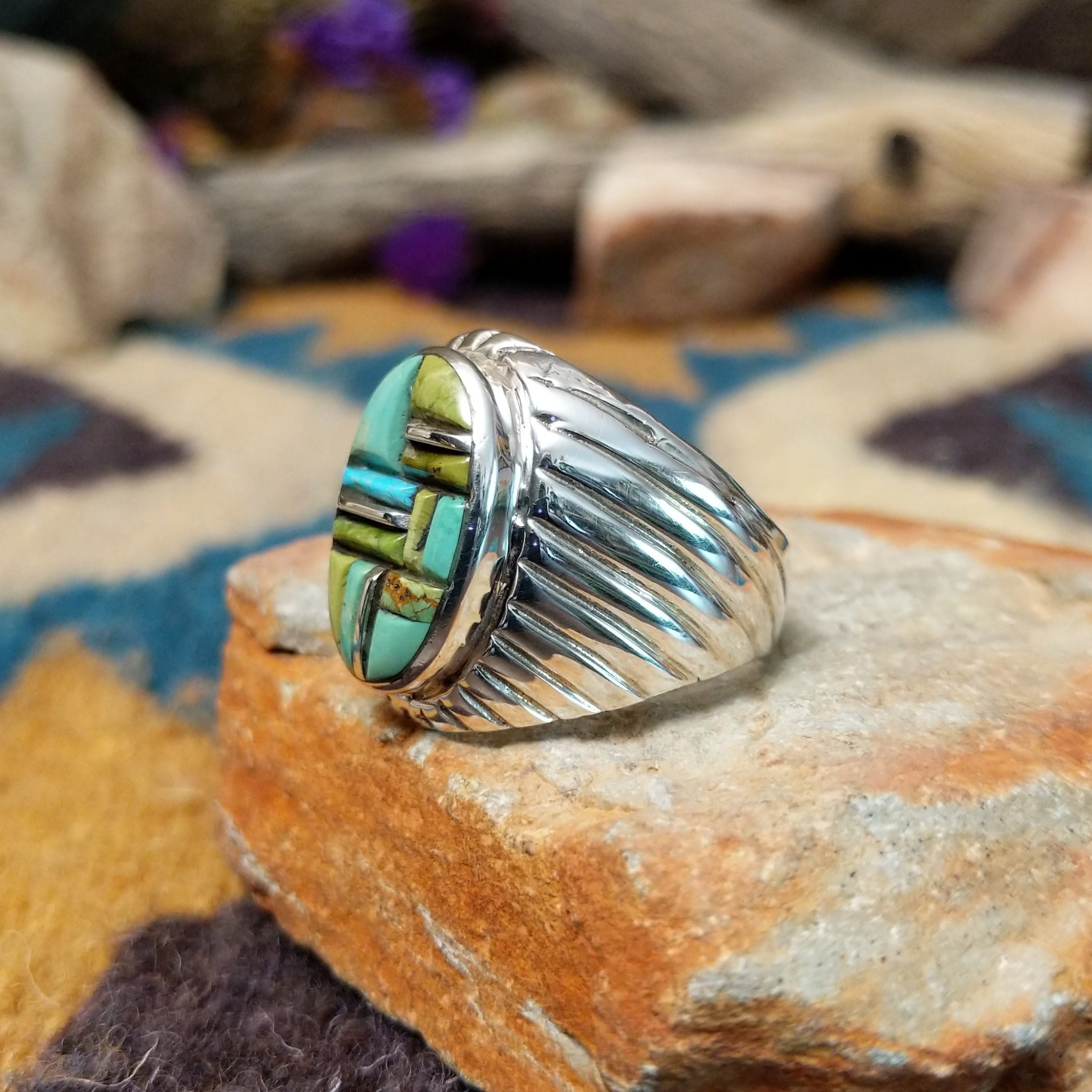 Sterling silver Turquoise inlay ring by L.C. with blue and green geometric strip inlay; side view.