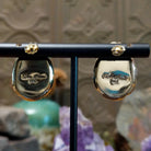 Close up of artist's stamped signature and 14K indicating 14 karat gold construction.