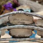 Handcrafted sterling silver cuff by Linda Johnson featuring three vibrant turquoise cabochons with twisted rope bezels, ornate silver beadwork, and a classic double-wire cuff design; artisan and Sterling Silver stamp.