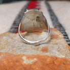 Turquoise Trio Ring by Pauline Nelson featuring three rectangular blue turquoise stones arranged vertically in serrated silver bezels, with detailed hand-stamped designs along the wide silver band; underside view.