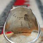 Turquoise Trio Ring by Pauline Nelson featuring three rectangular blue turquoise stones arranged vertically in serrated silver bezels, with detailed hand-stamped designs along the wide silver band; artisan and Sterling Silver stamp.