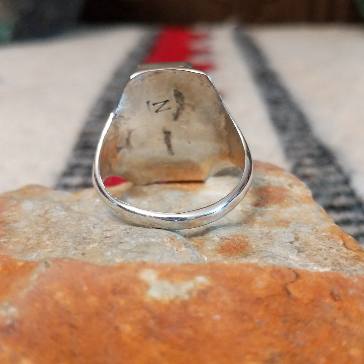 Three-stone turquoise silver ring by Pauline Nelson with stamped details.