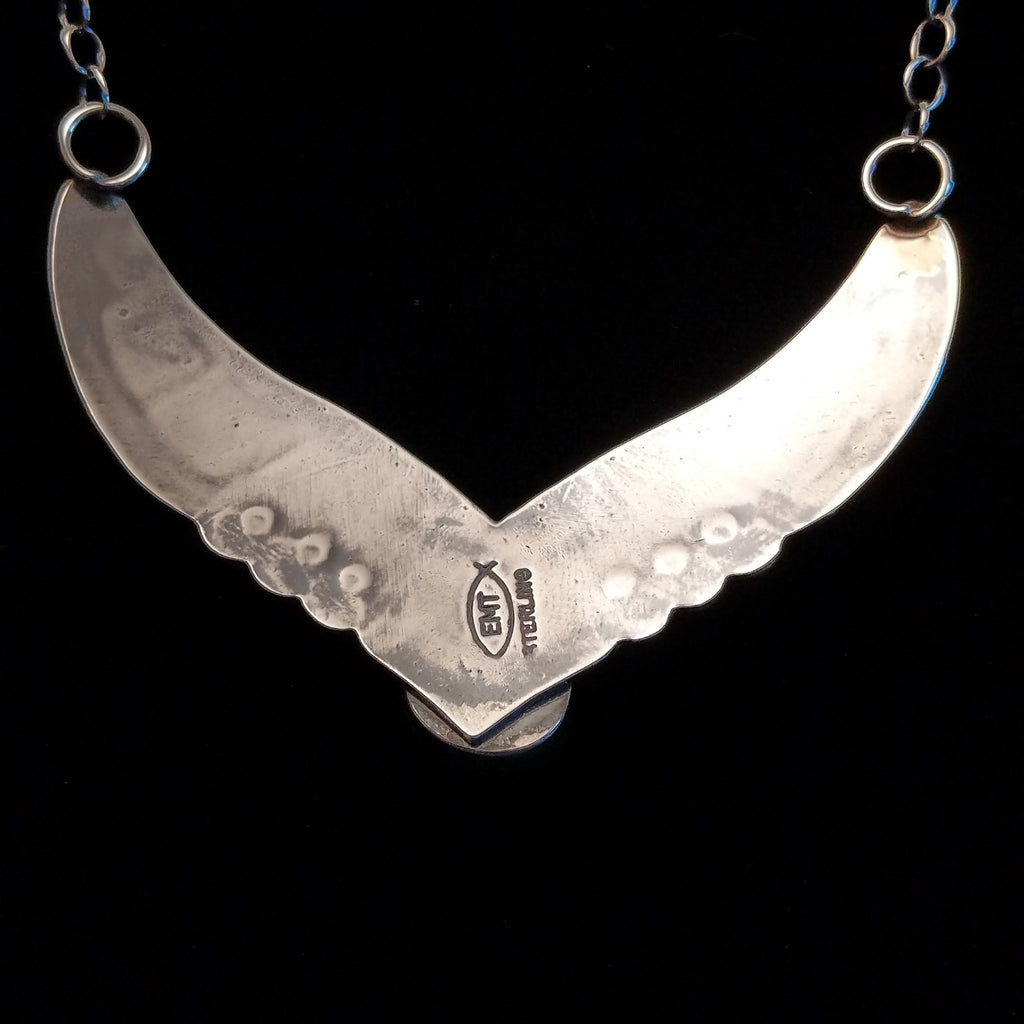 The back features the artisan's stamp.