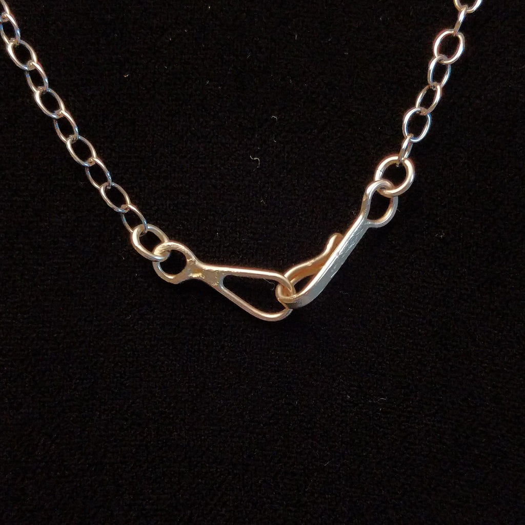 Close-up of the hook clasp on the necklace.