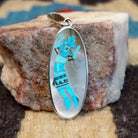 Sterling silver yei pendant featuring mother of pearl and turquoise inlays. 