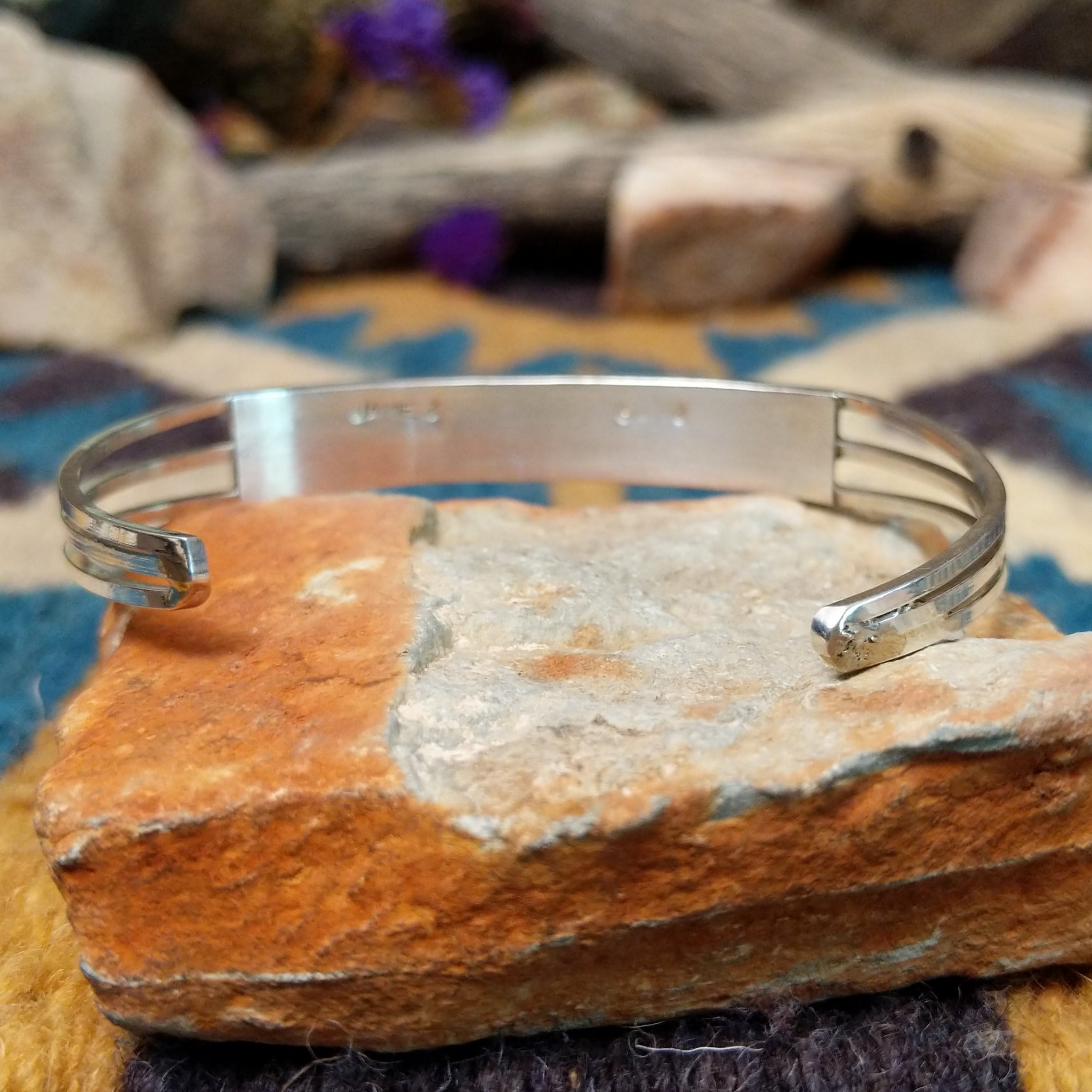 Handcrafted sterling silver two-row cuff by Jamie Johnson featuring vibrant Kingman turquoise channel inlay in a polished, minimalist Native American design; underside view.