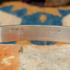 Handcrafted sterling silver two-row cuff by Jamie Johnson featuring vibrant Kingman turquoise channel inlay in a polished, minimalist Native American design; artisan and Sterling Silver stamp.