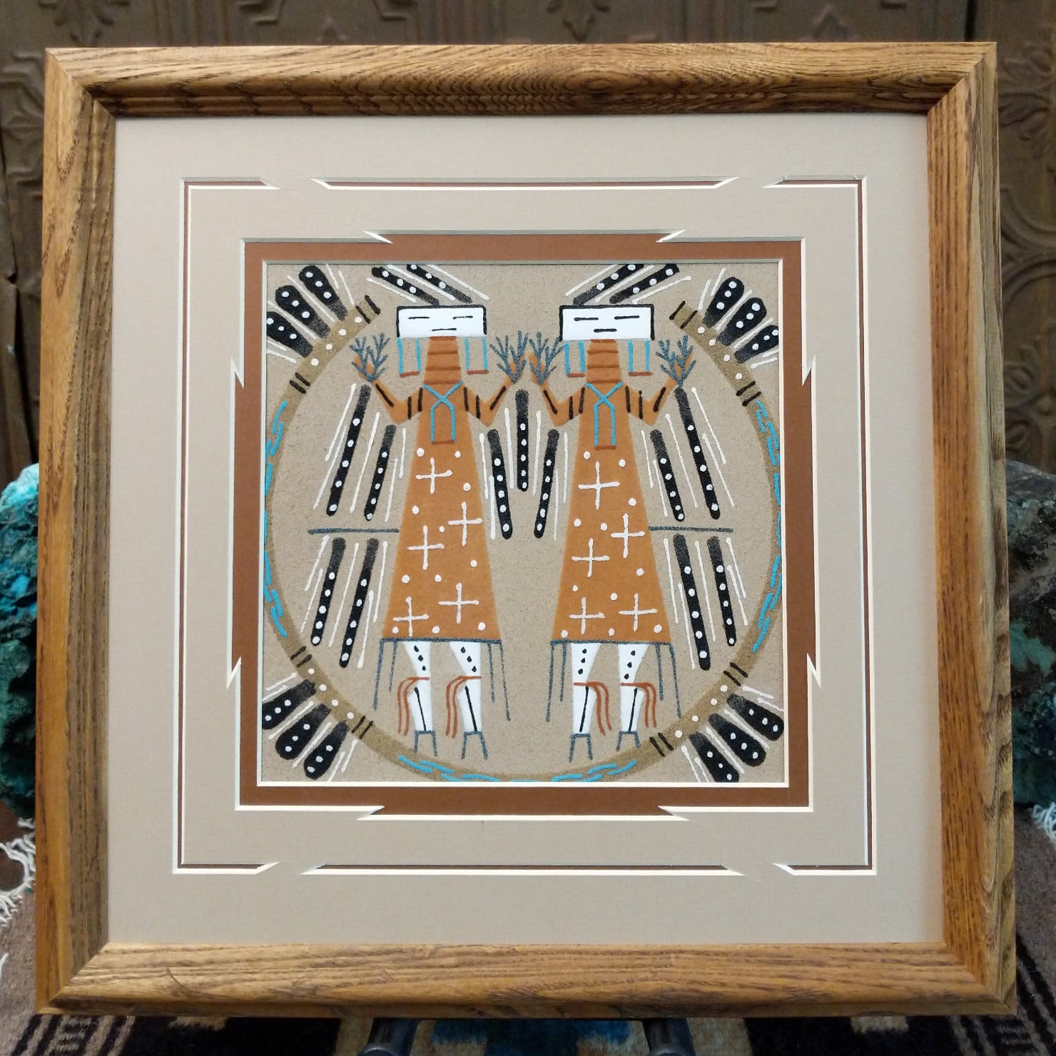 Framed Navajo sand painting of Two Yei figures with symbolic motifs. 