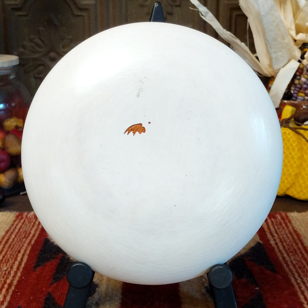 Bottom view of pot, all white with a buffalo hallmark as a signature