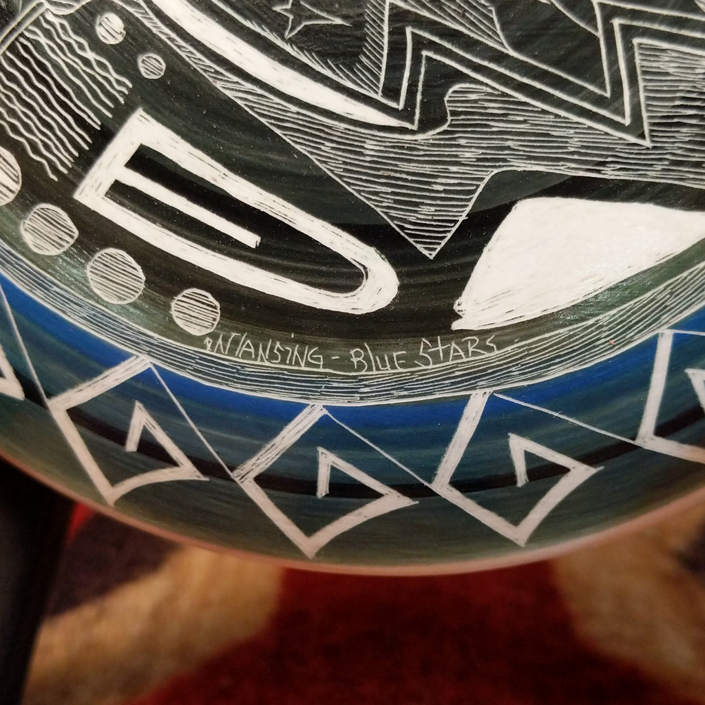 Close-up of the artisan's signature and title of the piece.