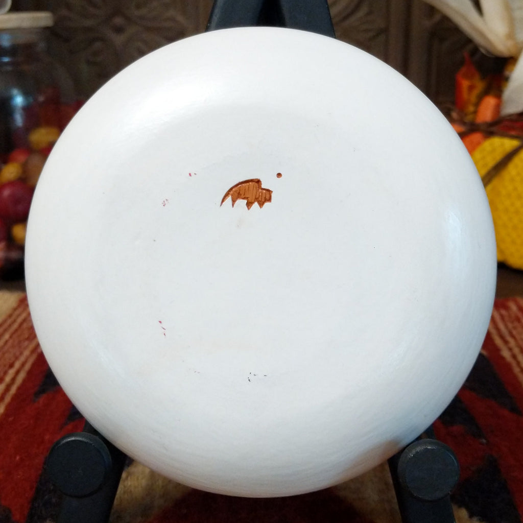 The underside features the artisan's buffalo trademark.