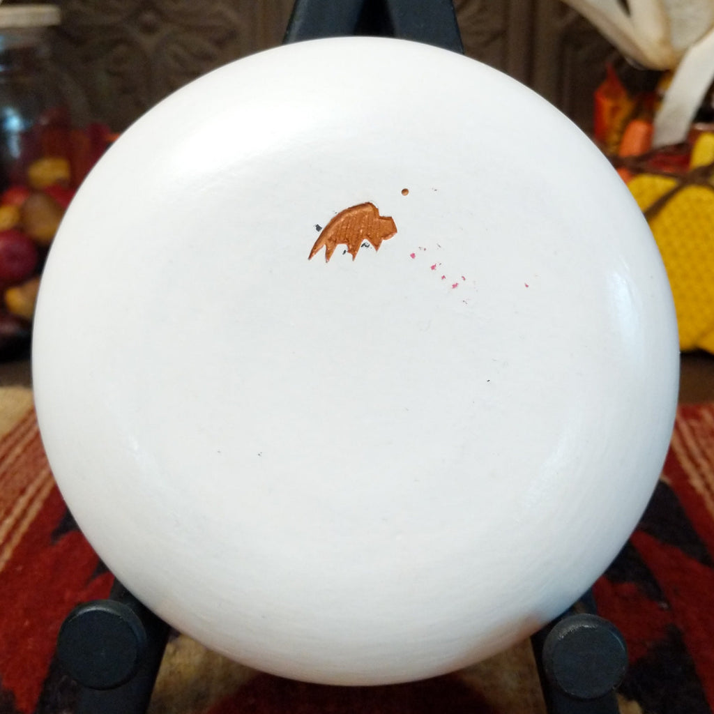 The underside of the piece showcases the artisan's buffalo trademark.