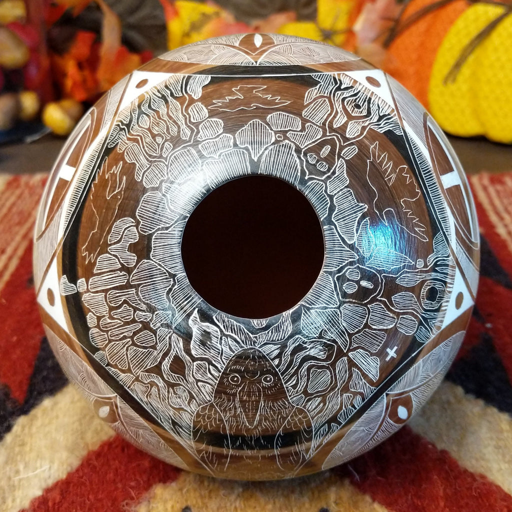 The pot lip is smooth with decorative carvings and a hallow interior.