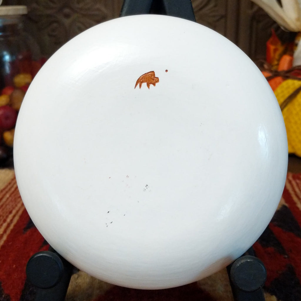 The underside of the piece features the artisan's buffalo trademark.
