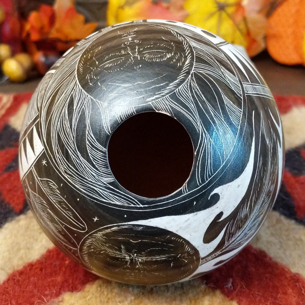 The opening of the pottery piece is smooth with designs.