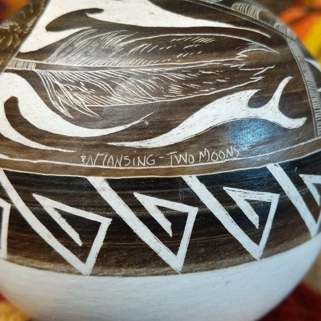 A close-up of the signature and title of the piece.