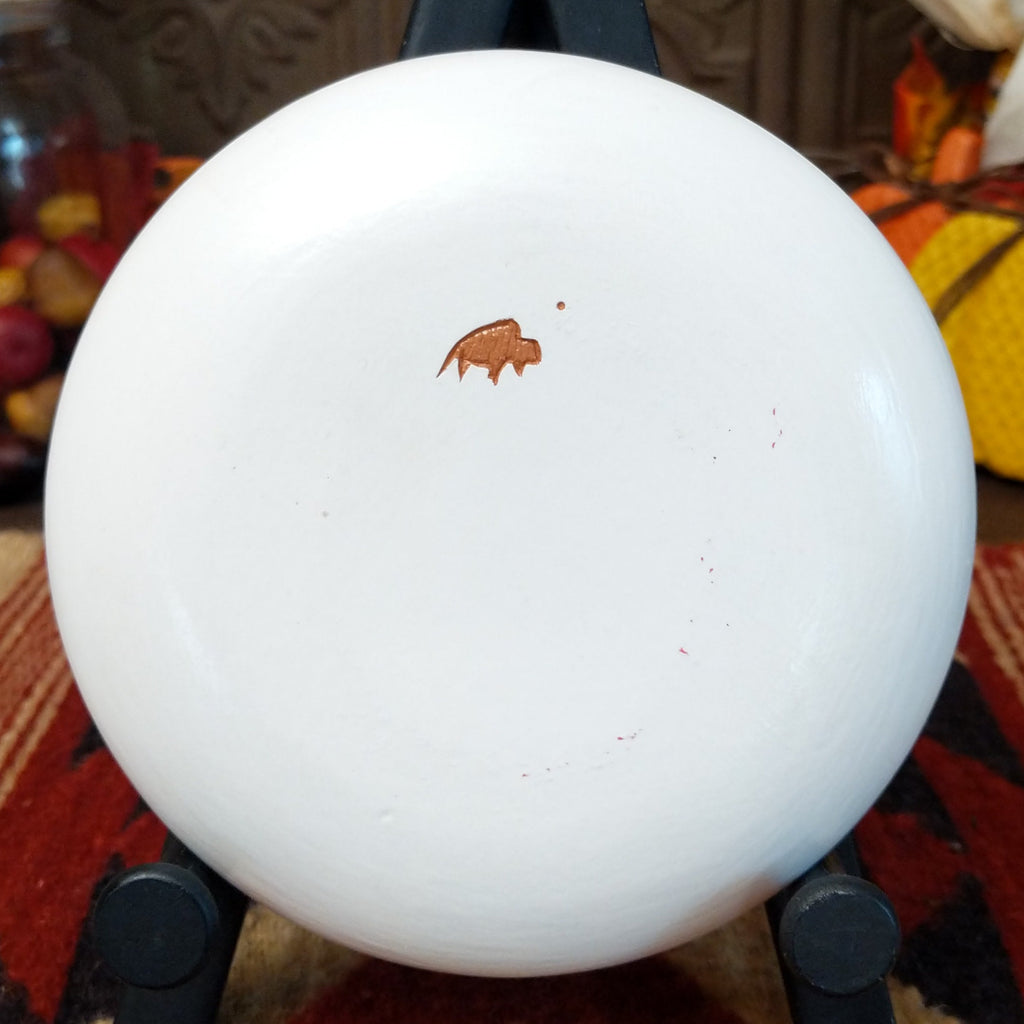 The underside of the piece features the artisan's buffalo trademark.