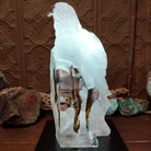 A frosted Lucite sculpture of a bald eagle with two hand-painted bald eagles soaring through the clear crystal interior; low light display.