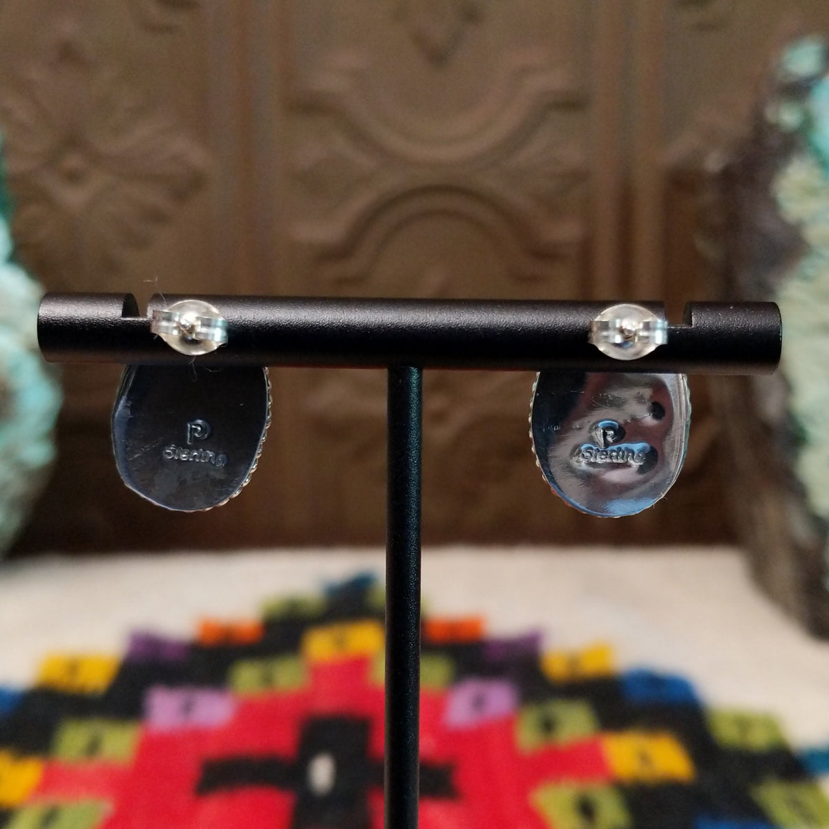 Warm Water Spiny Oyster Shell Oval Earrings by Priscilla Smith featuring polished coral-orange oval shell cabochons with natural color variations, set in silver with twisted rope-style borders; artisan and Sterling Silver stamp.