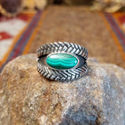 Sterling silver ring with oval malachite set in the bezel and weave patterned band.