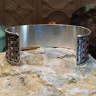 Wide sterling silver cuff bracelet with a woven basketweave pattern and twisted rope borders.
