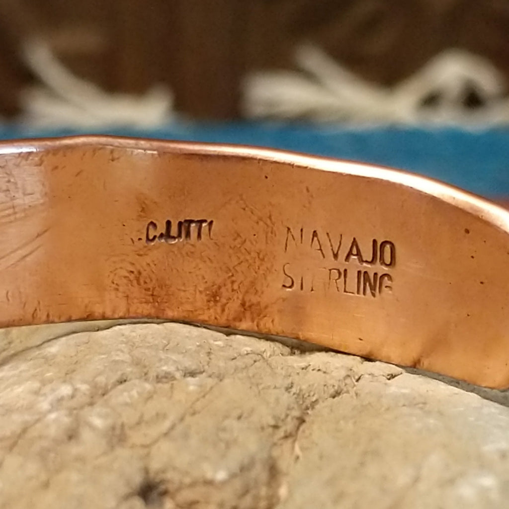 Close-up of the artisan's stamped signature.