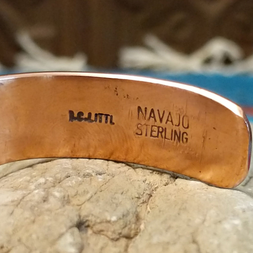 Close-up of the artisan's stamped signature.